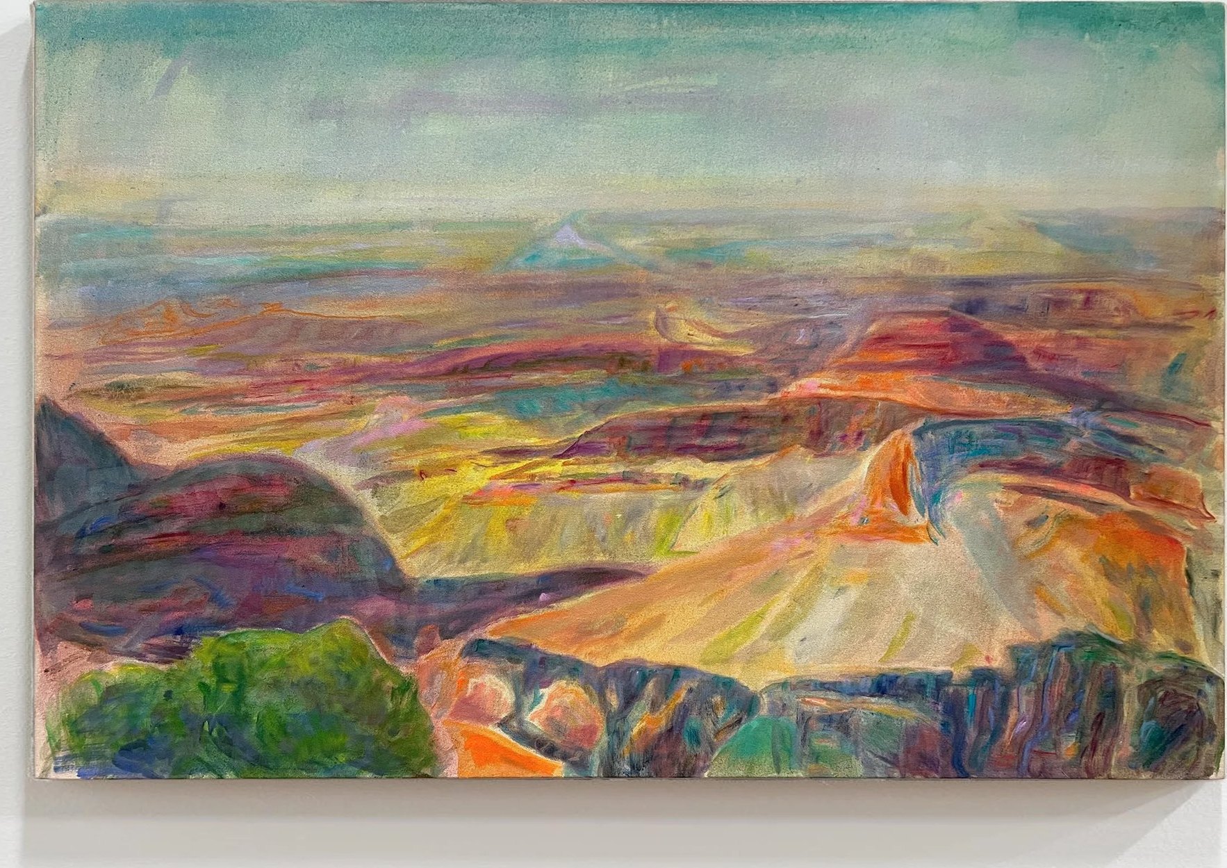 Grand Canyon: canyon ridges glowing orange and red beneath a pale sky